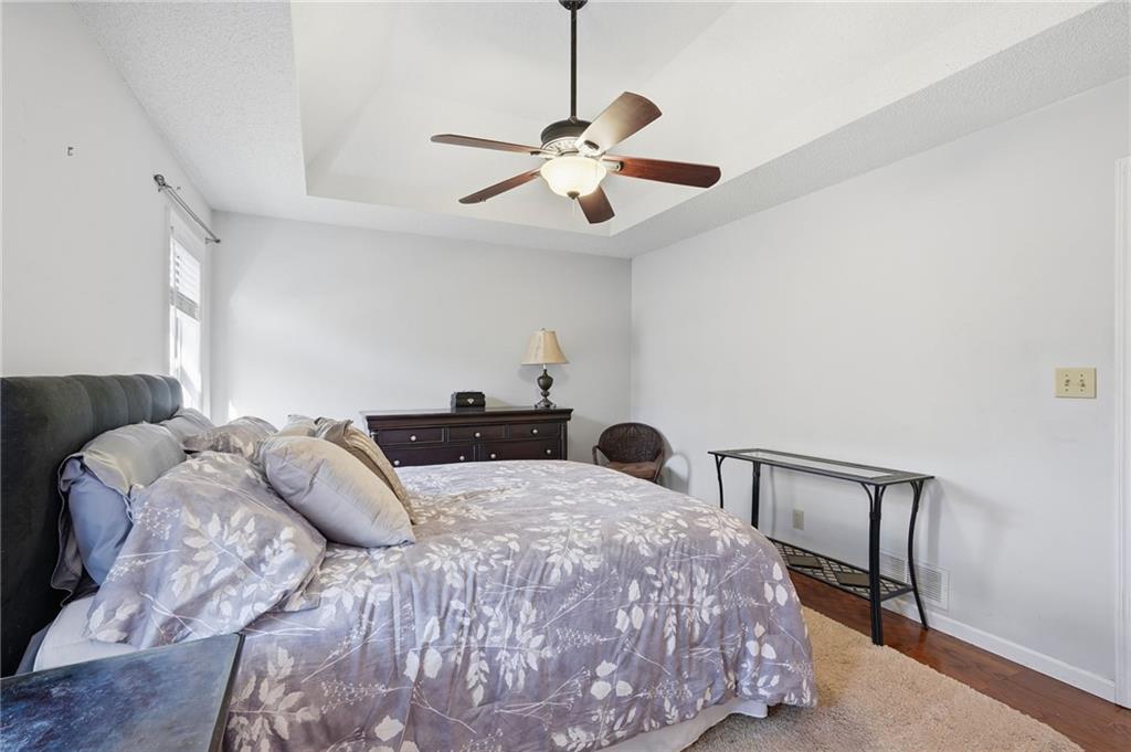 2240 McBrayer Court Cumming, GA 30028 - Photo 17 of 35 a bedroom with a bed and a chandelier