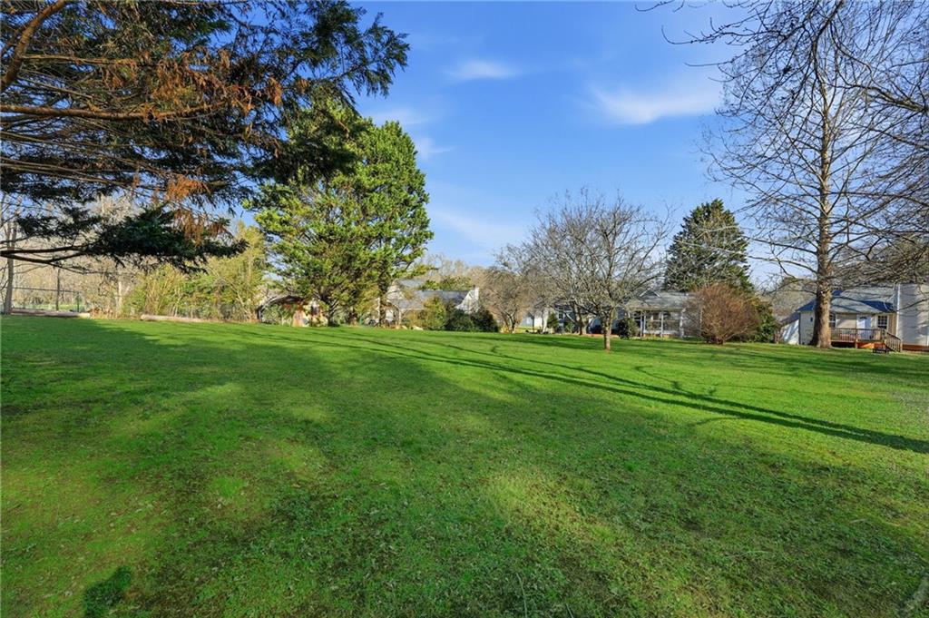 2240 McBrayer Court Cumming, GA 30028 - Photo 28 of 35 a backyard of a house with lots of green space
