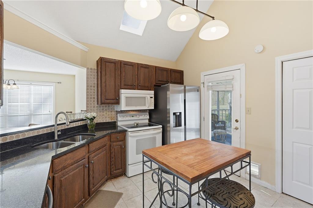 2240 McBrayer Court Cumming, GA 30028 - Photo 10 of 35 a kitchen with stainless steel appliances a sink stove and refrigerator