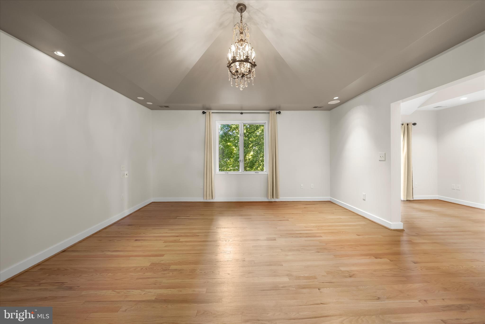 5104 Scarsdale Road Bethesda, MD 20816 - Photo 33 of 68 a view of an empty room with wooden floor and a window