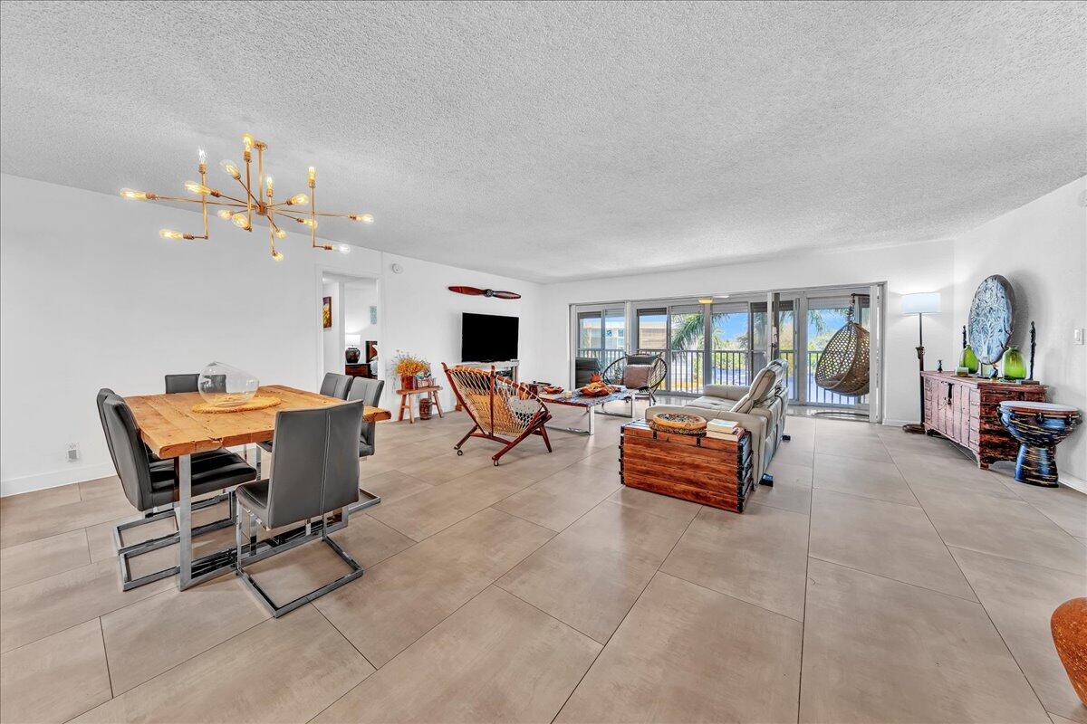 1523 East Hillsboro Boulevard, Unit 531 Deerfield Beach, FL 33441 - Photo 18 of 71 a living room with furniture and a chandelier