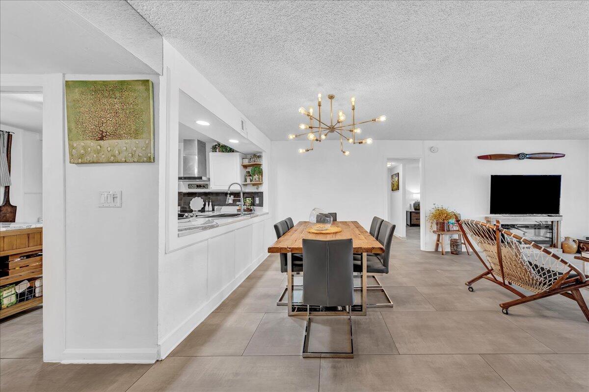 1523 East Hillsboro Boulevard, Unit 531 Deerfield Beach, FL 33441 - Photo 19 of 71 a view of a dining room with furniture and a kitchen