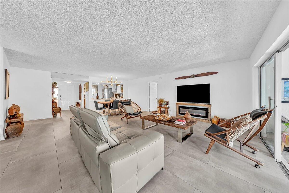 1523 East Hillsboro Boulevard, Unit 531 Deerfield Beach, FL 33441 - Photo 21 of 71 a living room with furniture and a flat screen tv