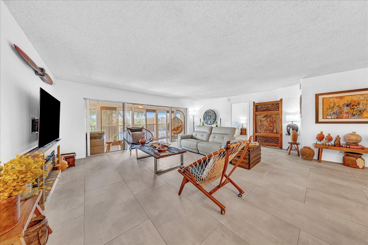 1523 East Hillsboro Boulevard, Unit 531 Deerfield Beach, FL 33441 - Photo 24 of 71 a living room with furniture and a flat screen tv