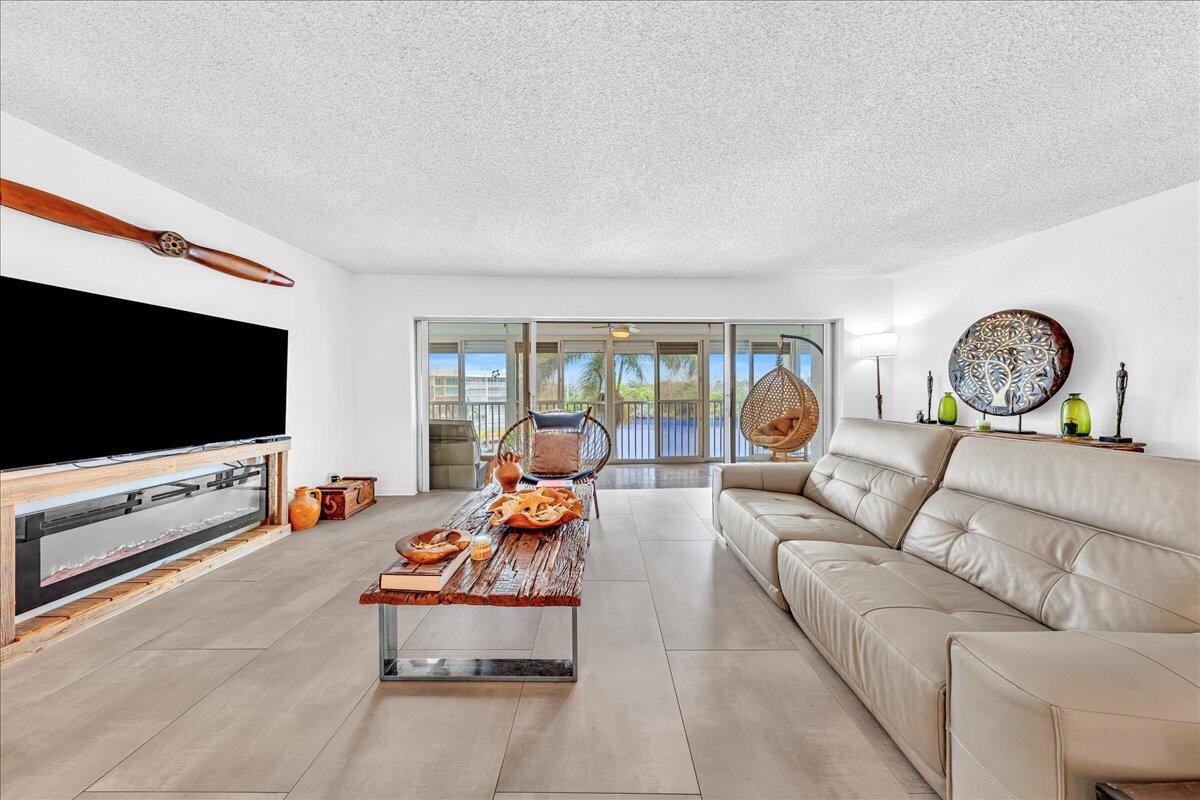 1523 East Hillsboro Boulevard, Unit 531 Deerfield Beach, FL 33441 - Photo 26 of 71 a living room with furniture and a flat screen tv