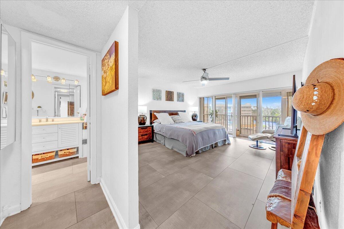 1523 East Hillsboro Boulevard, Unit 531 Deerfield Beach, FL 33441 - Photo 27 of 71 a bedroom with furniture and a mirror