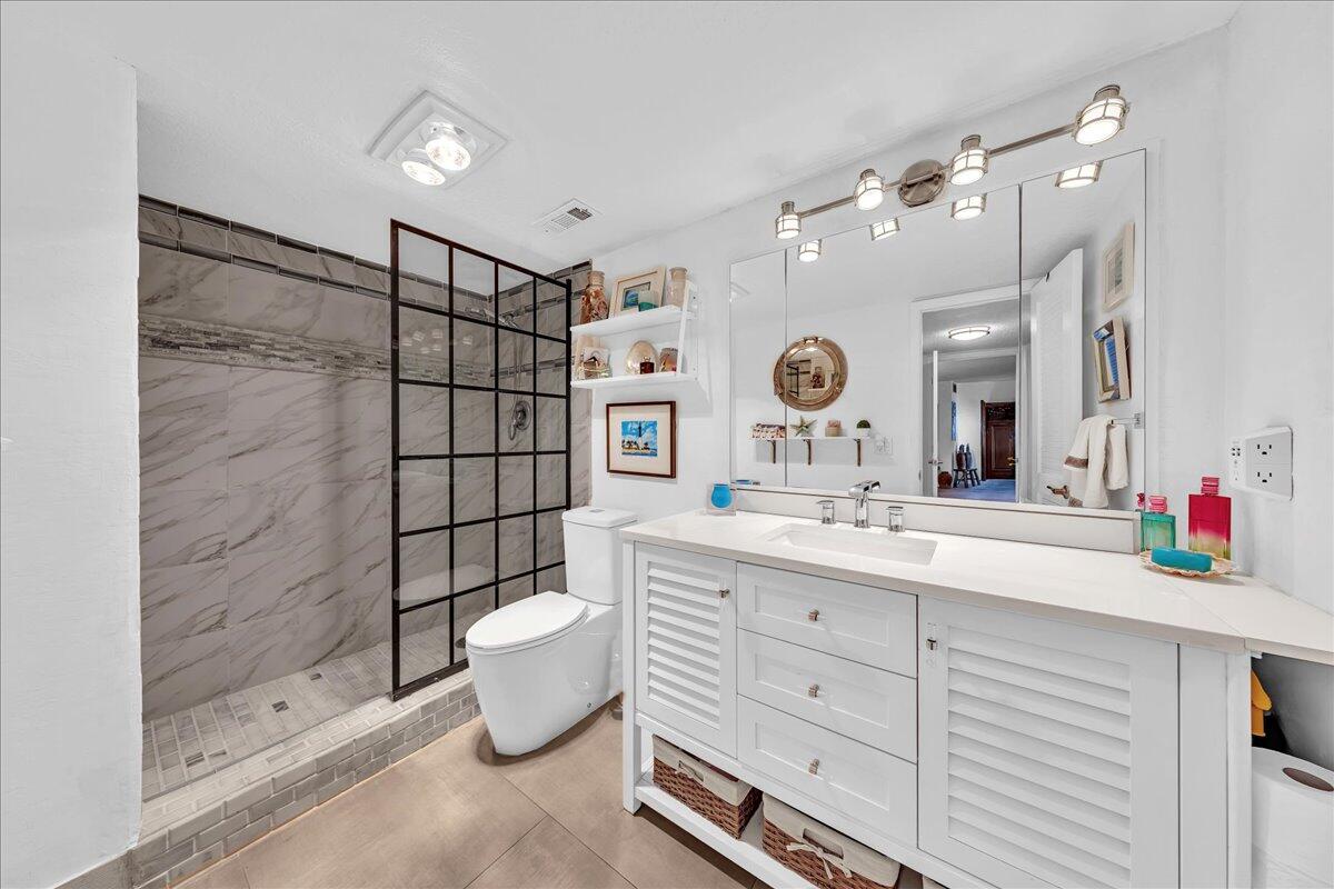 1523 East Hillsboro Boulevard, Unit 531 Deerfield Beach, FL 33441 - Photo 30 of 71 a bathroom with a double vanity sink mirror and shower