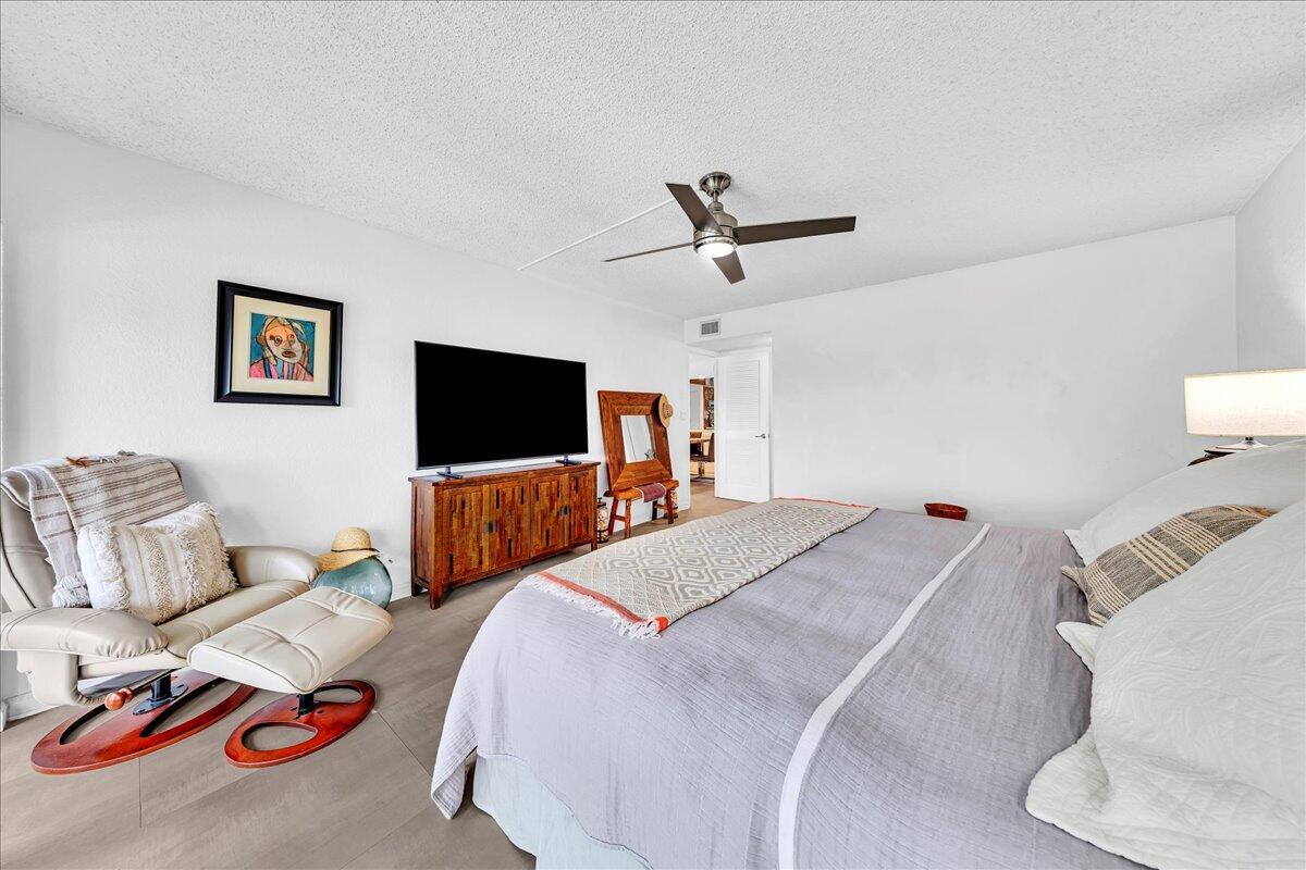 1523 East Hillsboro Boulevard, Unit 531 Deerfield Beach, FL 33441 - Photo 34 of 71 a bedroom with a bed and a flat screen tv