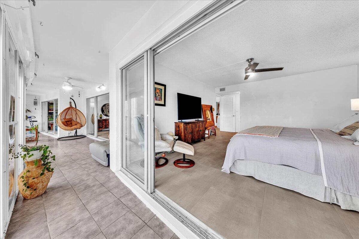 1523 East Hillsboro Boulevard, Unit 531 Deerfield Beach, FL 33441 - Photo 36 of 71 a bedroom with furniture and a flat screen tv