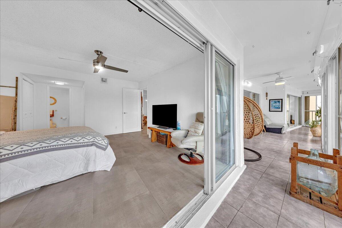 1523 East Hillsboro Boulevard, Unit 531 Deerfield Beach, FL 33441 - Photo 41 of 71 a spacious bedroom with a bed and a flat screen tv