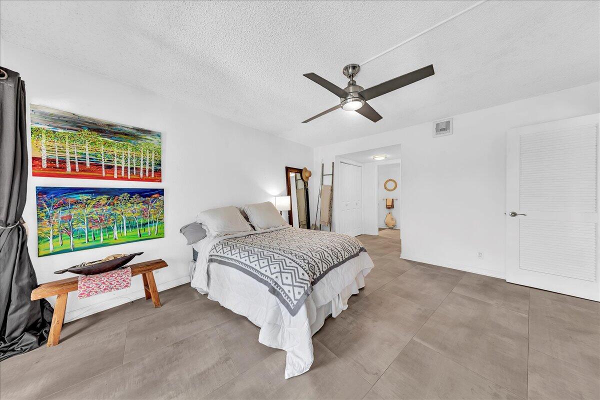 1523 East Hillsboro Boulevard, Unit 531 Deerfield Beach, FL 33441 - Photo 43 of 71 a spacious bedroom with a bed a couch and a window