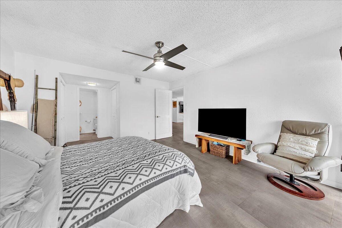 1523 East Hillsboro Boulevard, Unit 531 Deerfield Beach, FL 33441 - Photo 44 of 71 a bedroom with a bed and a flat screen tv