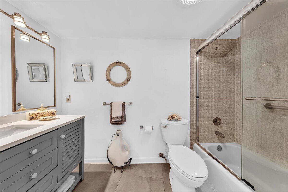 1523 East Hillsboro Boulevard, Unit 531 Deerfield Beach, FL 33441 - Photo 46 of 71 a bathroom with a granite countertop sink toilet and shower