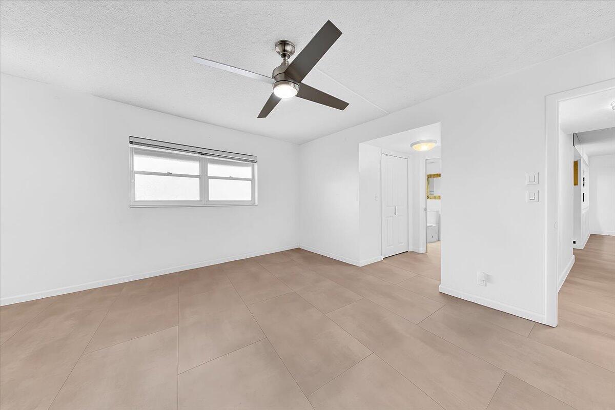 1523 East Hillsboro Boulevard, Unit 531 Deerfield Beach, FL 33441 - Photo 52 of 71 an empty room with windows and ceiling fan