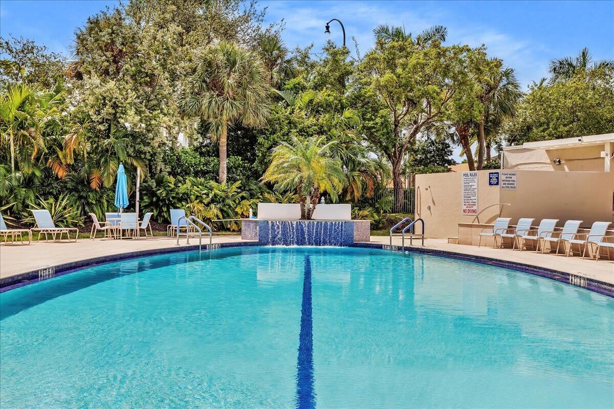 1523 East Hillsboro Boulevard, Unit 531 Deerfield Beach, FL 33441 - Photo 57 of 71 a swimming pool with outdoor seating and yard