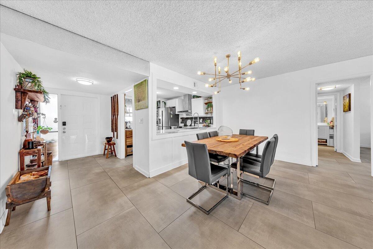 1523 East Hillsboro Boulevard, Unit 531 Deerfield Beach, FL 33441 - Photo 7 of 71 a view of a dining room with furniture and chandelier