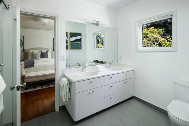 a spacious bathroom with a double vanity sink and a mirror