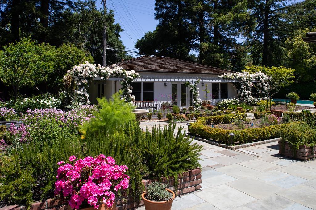 296 Greenoaks Drive Atherton, CA 94027 - Photo 17 of 21 a front view of a house with a yard and fountain