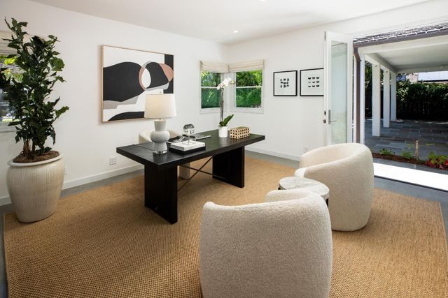 a living room with furniture and a potted plant