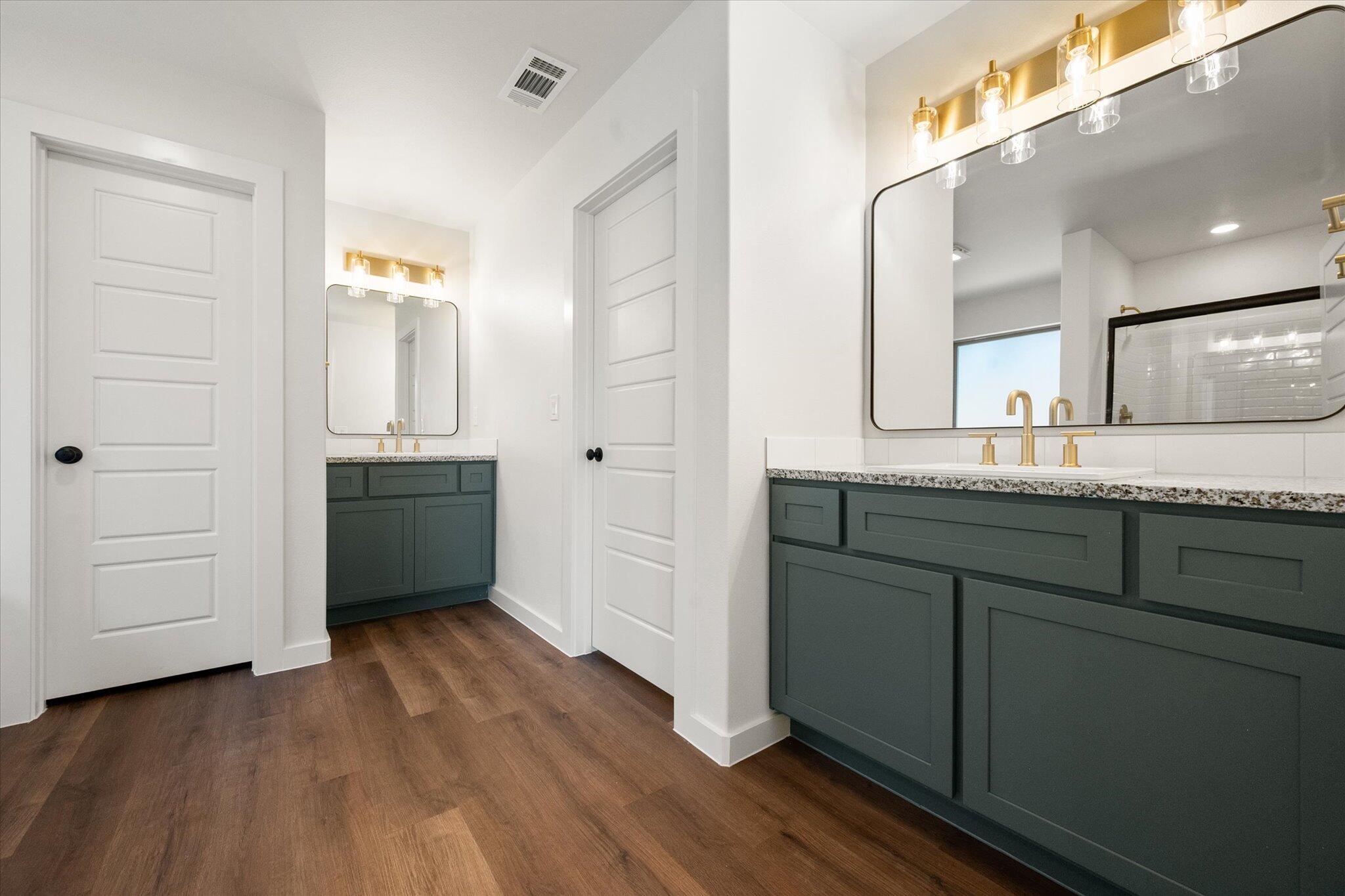 7007 16th Street Lubbock, TX 79416 - Photo 14 of 24 a bathroom with a sink and mirror