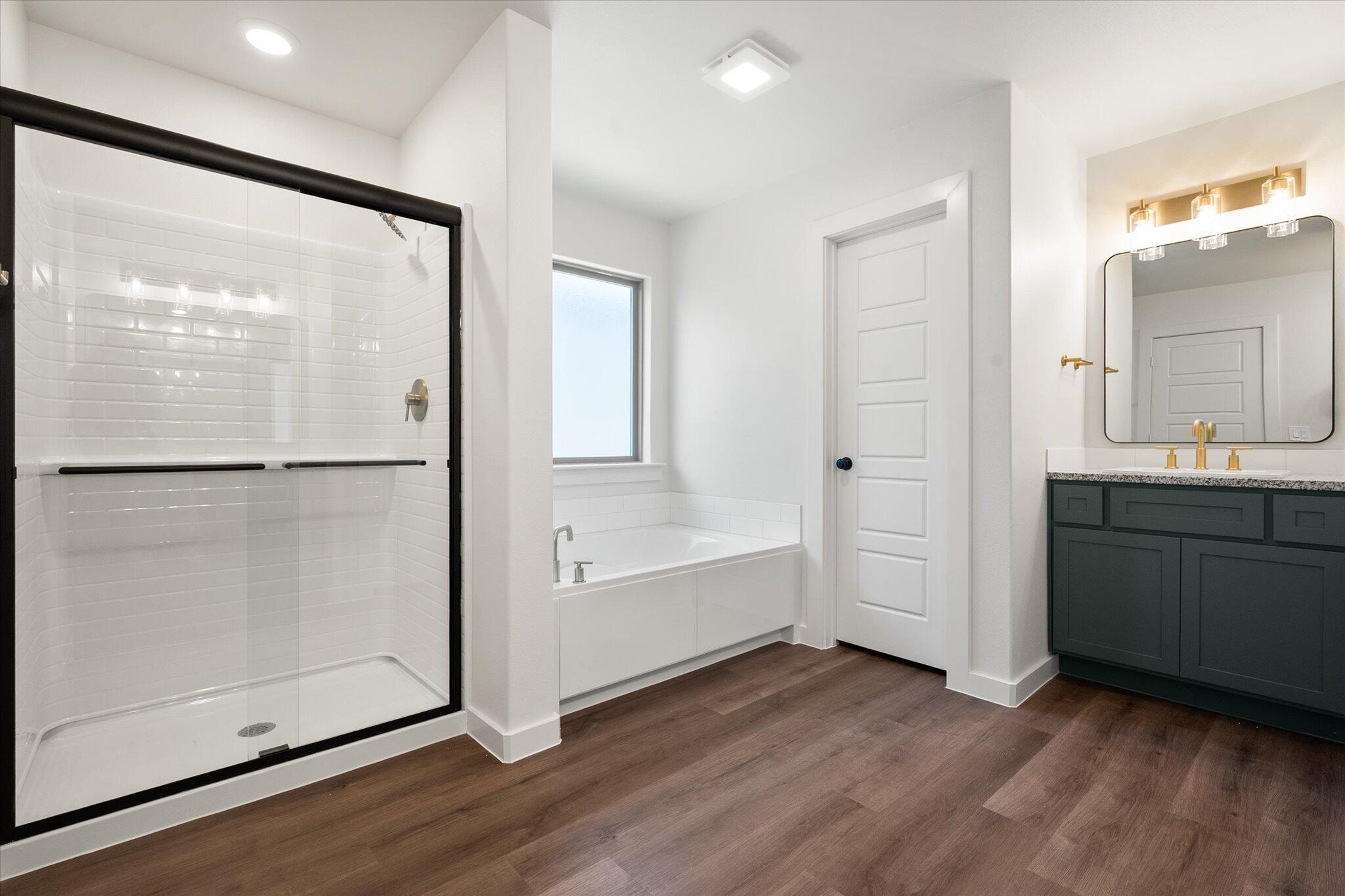 7007 16th Street Lubbock, TX 79416 - Photo 16 of 24 a bathroom with a bathtub and a sink