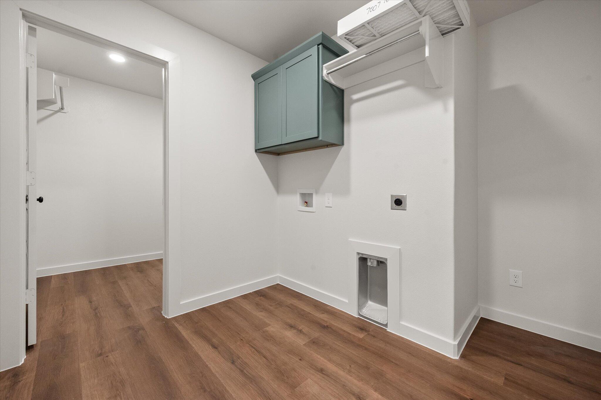 7007 16th Street Lubbock, TX 79416 - Photo 18 of 24 a view of an empty room with wooden floor and a window