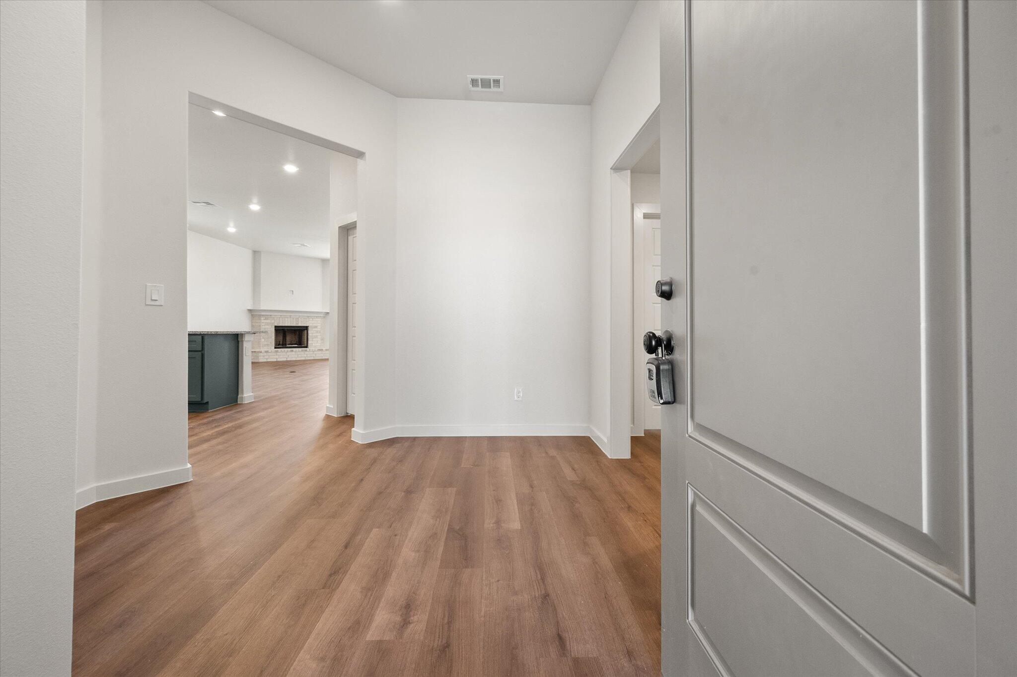7007 16th Street Lubbock, TX 79416 - Photo 2 of 24 a view of empty room with wooden floor