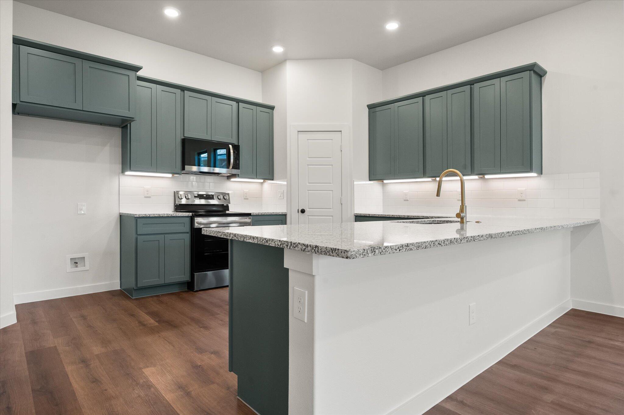 7007 16th Street Lubbock, TX 79416 - Photo 5 of 24 a kitchen with stainless steel appliances a sink and a refrigerator