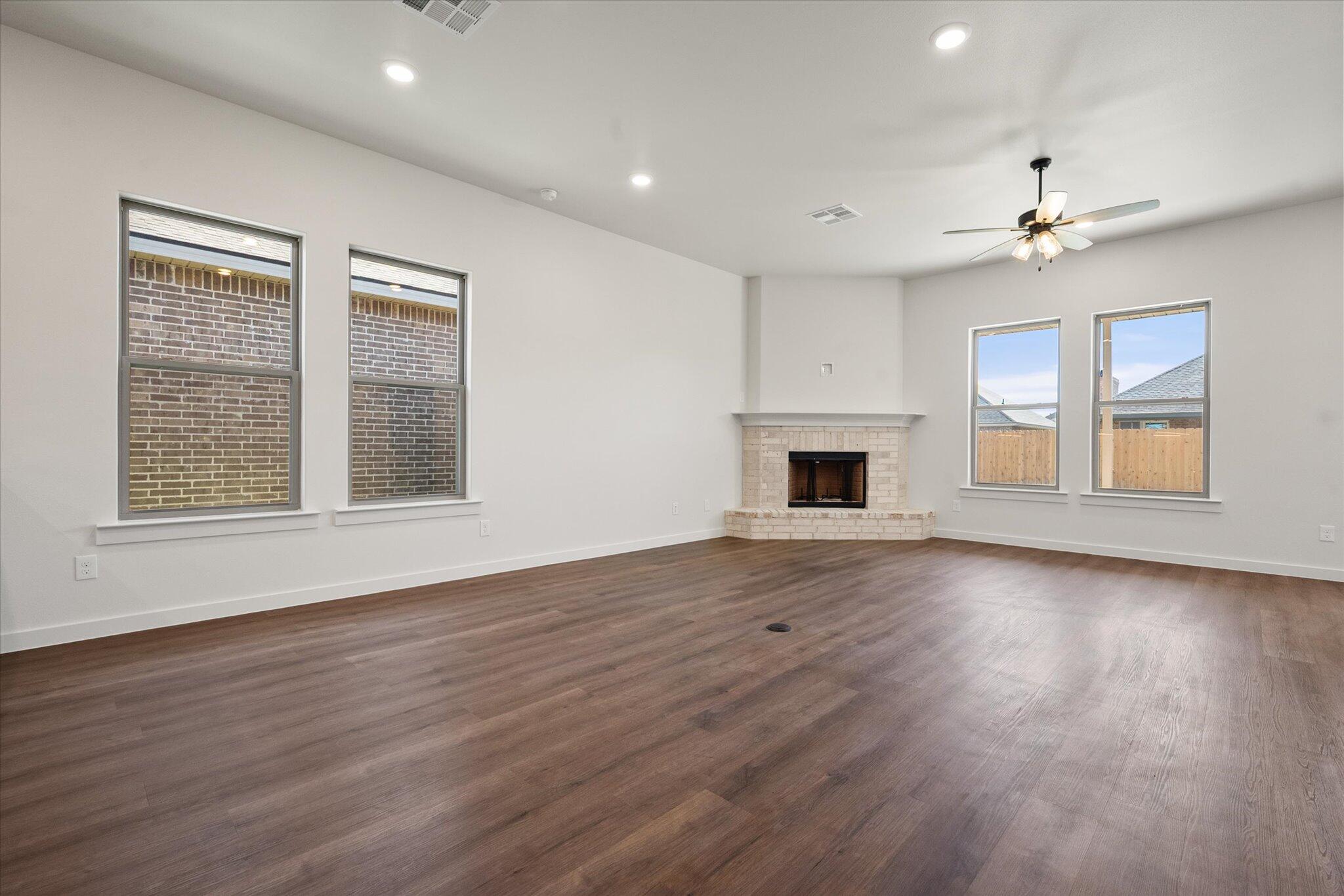 7007 16th Street Lubbock, TX 79416 - Photo 8 of 24 a view of an empty room with wooden floor and a window