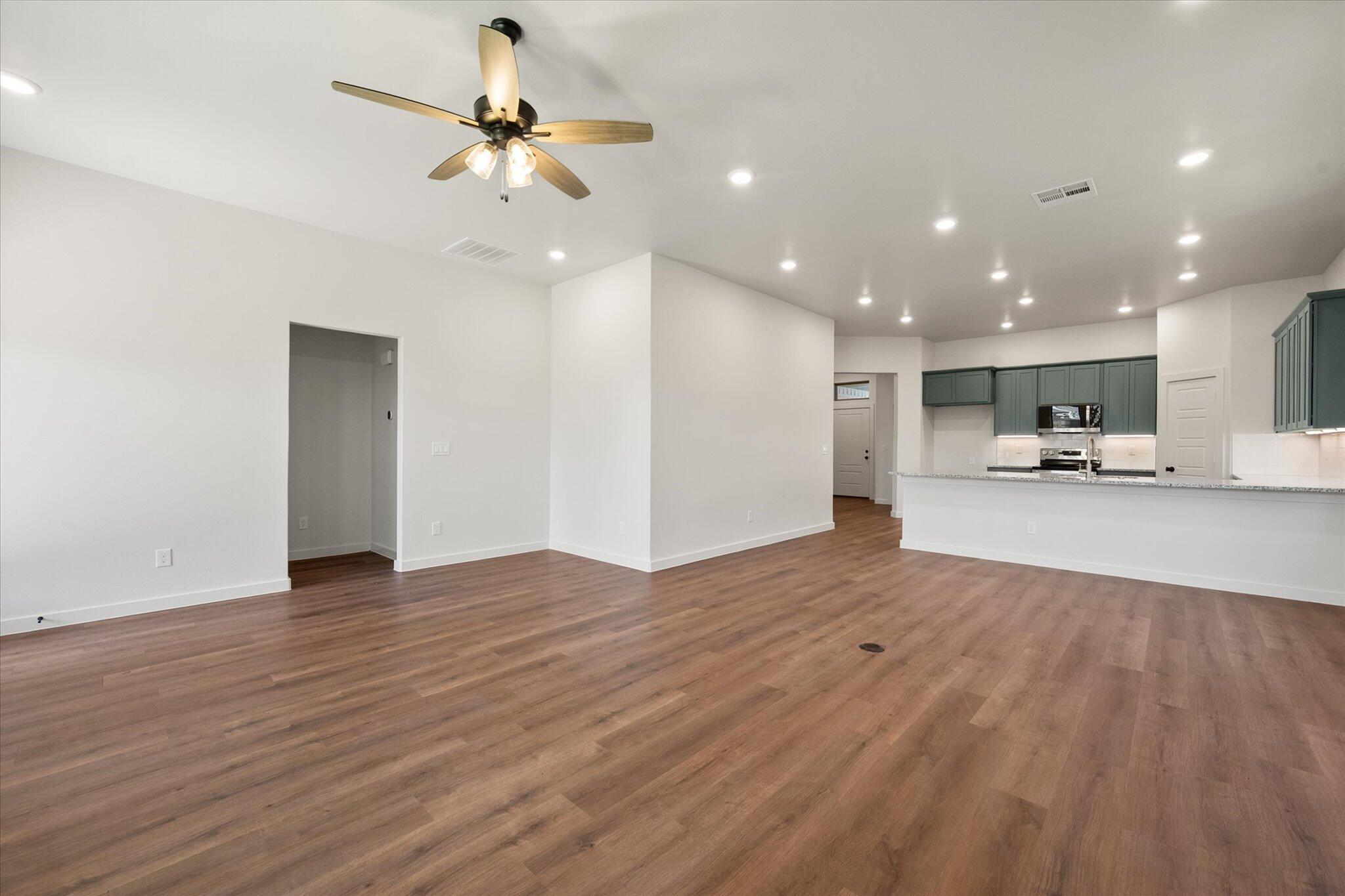 7007 16th Street Lubbock, TX 79416 - Photo 10 of 24 a view of kitchen and livingroom with furniture wooden floor