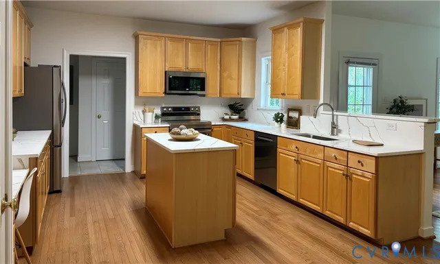 a kitchen with a sink stove and refrigerator