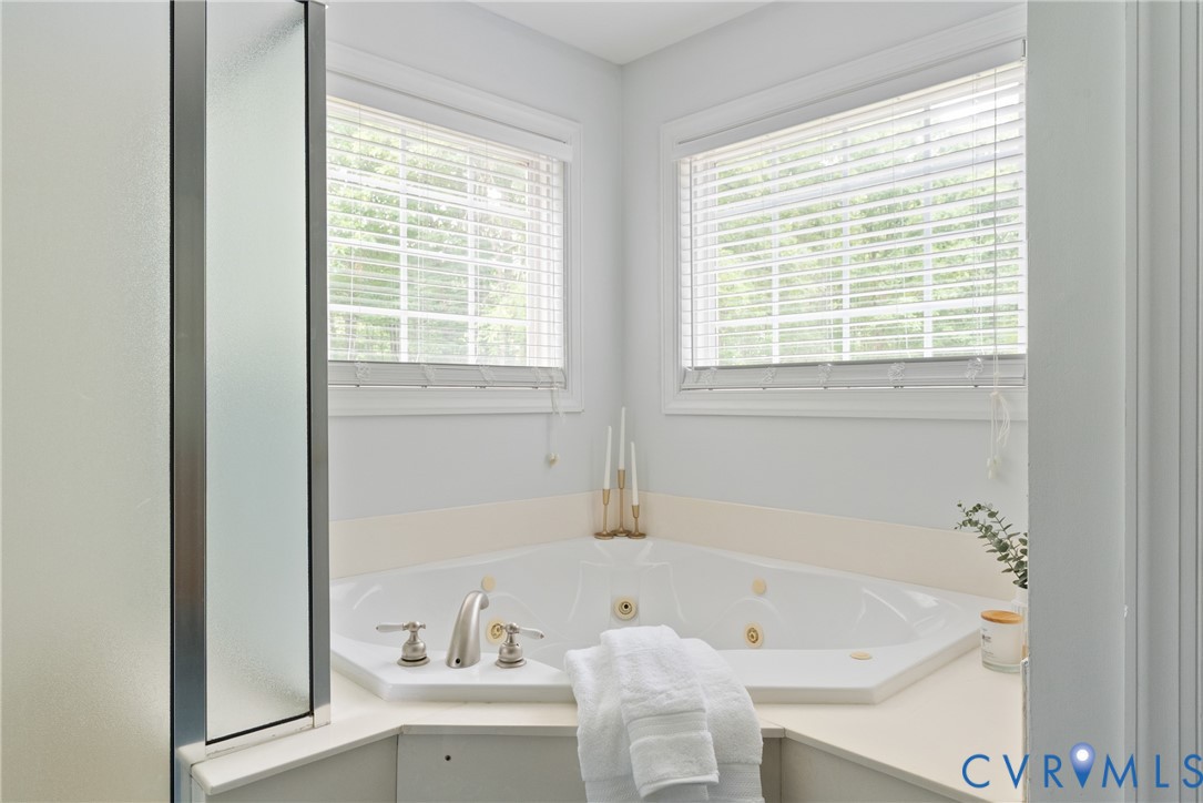 4156 Royal Ridge Court Louisa, VA 23093 - Photo 33 of 50 a bath tub sitting in a bathroom next to a window
