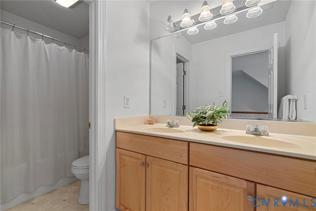 4156 Royal Ridge Court Louisa, VA 23093 - Photo 41 of 50 a bathroom with a double vanity sink toilet and a mirror
