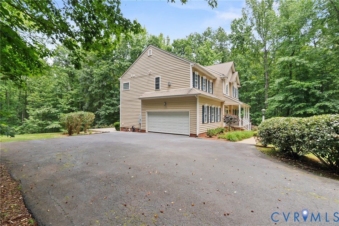 4156 Royal Ridge Court Louisa, VA 23093 - Photo 48 of 50 a view of a house with a yard and garage