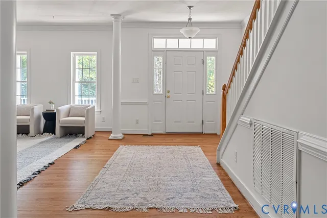 a living room with furniture rug and window