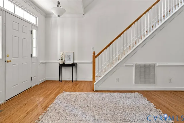 a living room with furniture a rug and a table