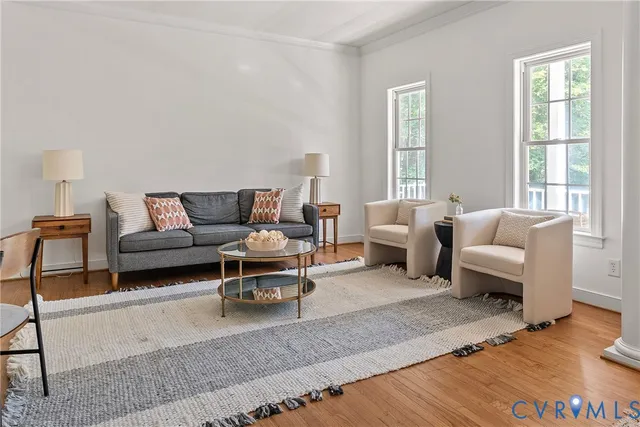 a living room with furniture a window and a table