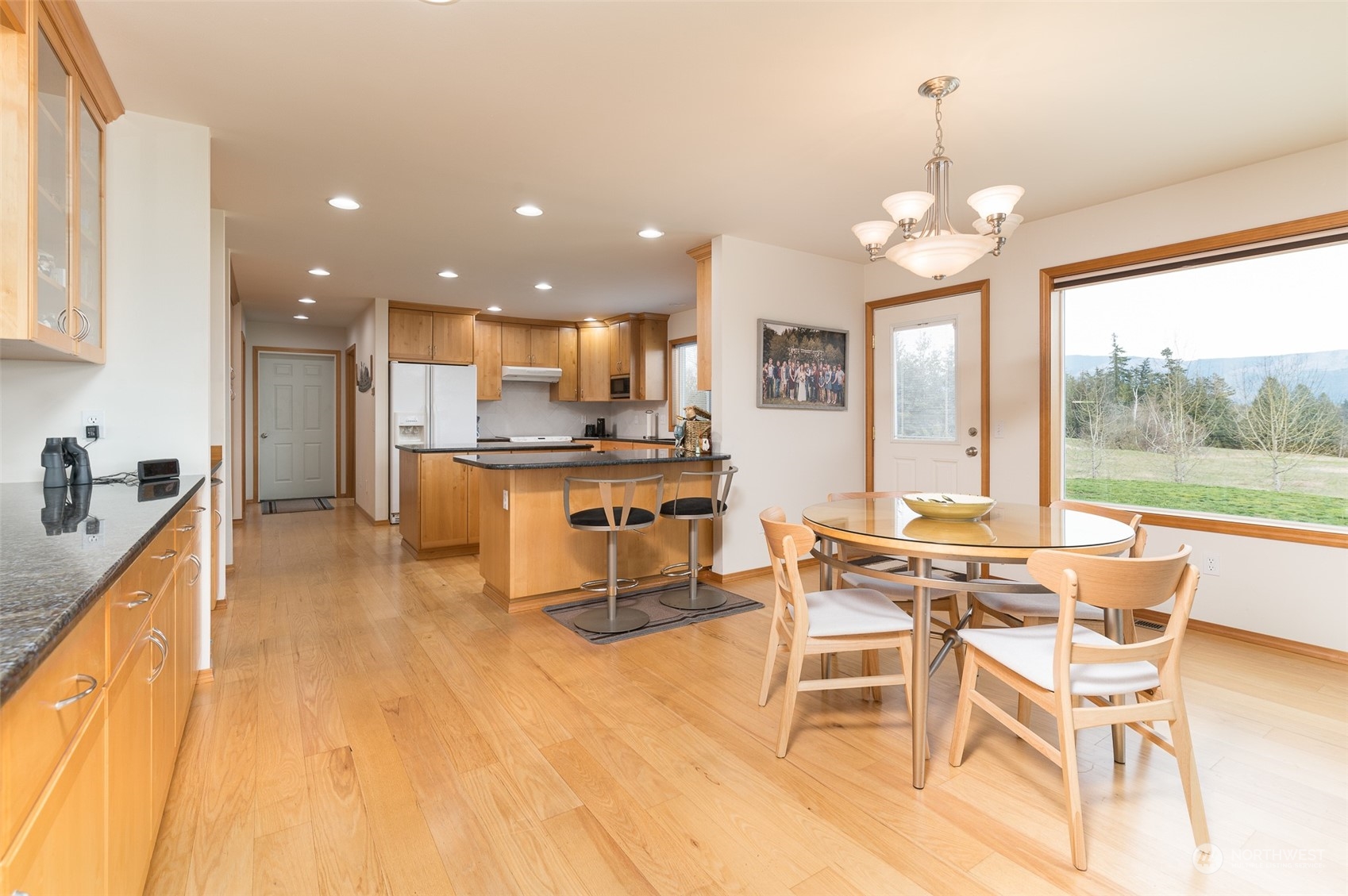 2131 Central Road Everson, WA 98247 - Photo 12 of 40 a view of a dining room with furniture a chandelier and wooden floor