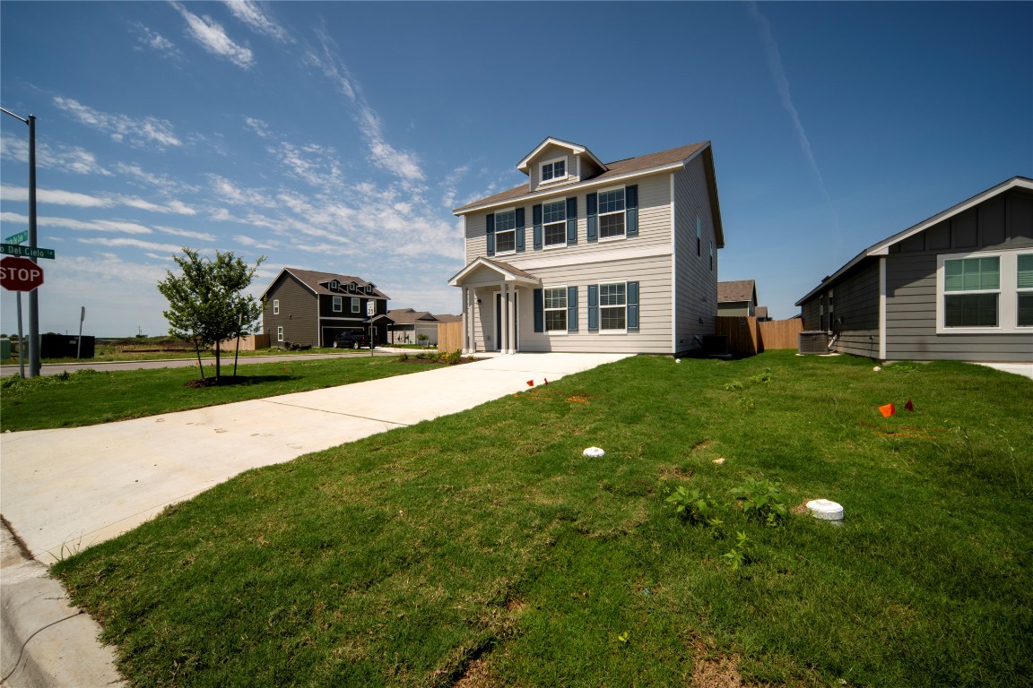a view of a house with a yard and sitting area