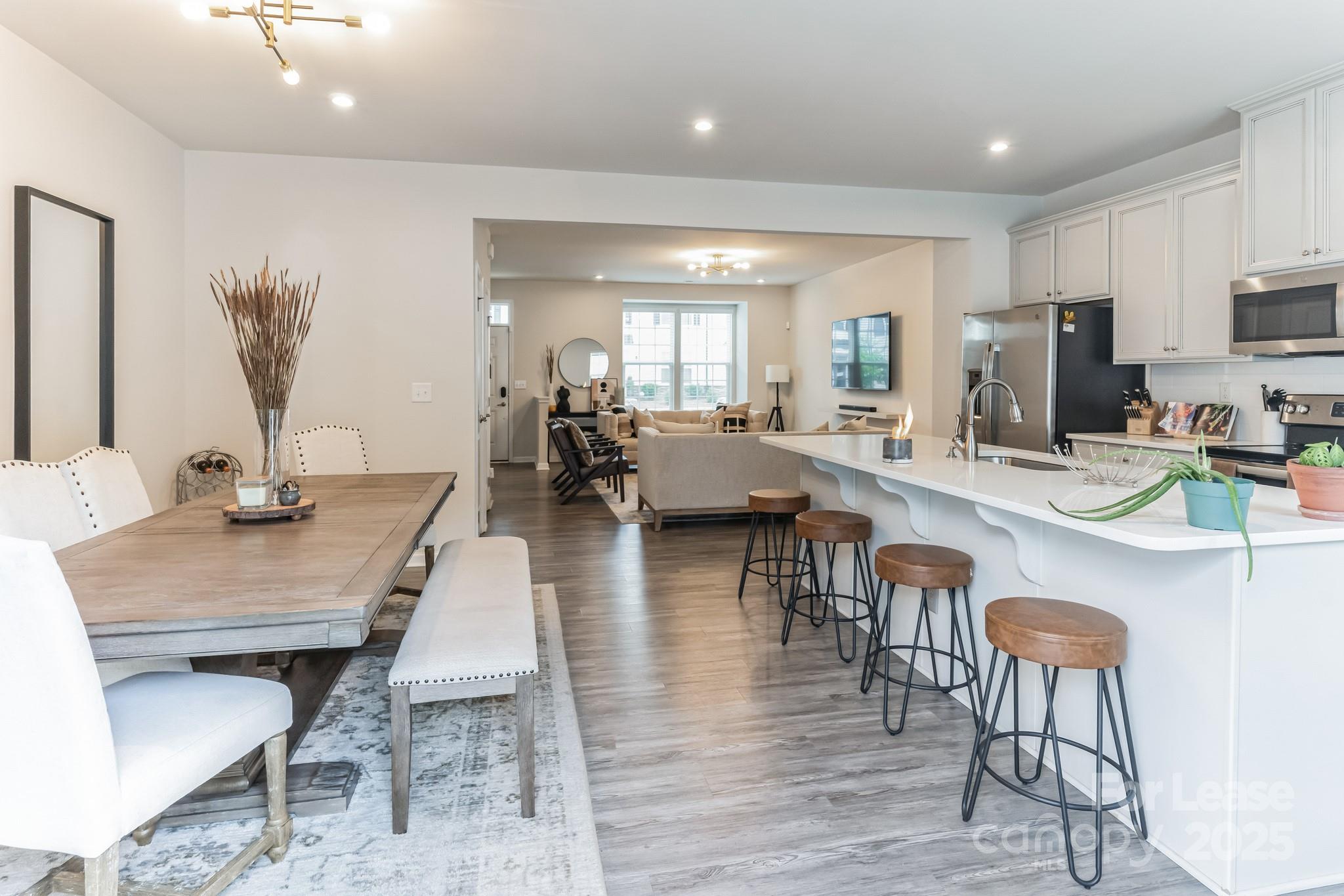 5048 Patton Dr. Gastonia, NC 28056 - Photo 12 of 37 a living room with furniture kitchen view and a wooden floor