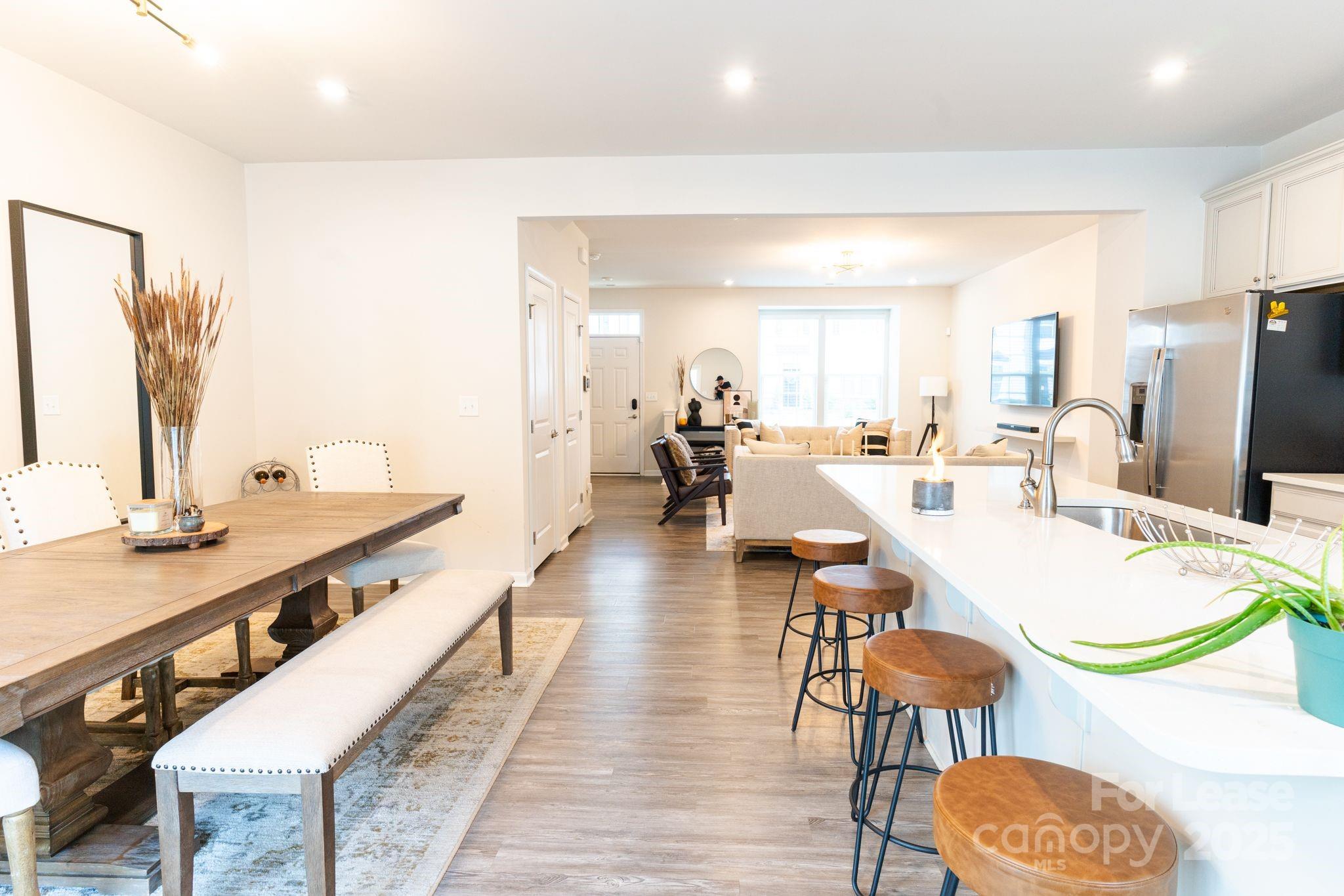 5048 Patton Dr. Gastonia, NC 28056 - Photo 13 of 37 a large living room with stainless steel appliances kitchen island granite countertop a dining table chairs and a large window