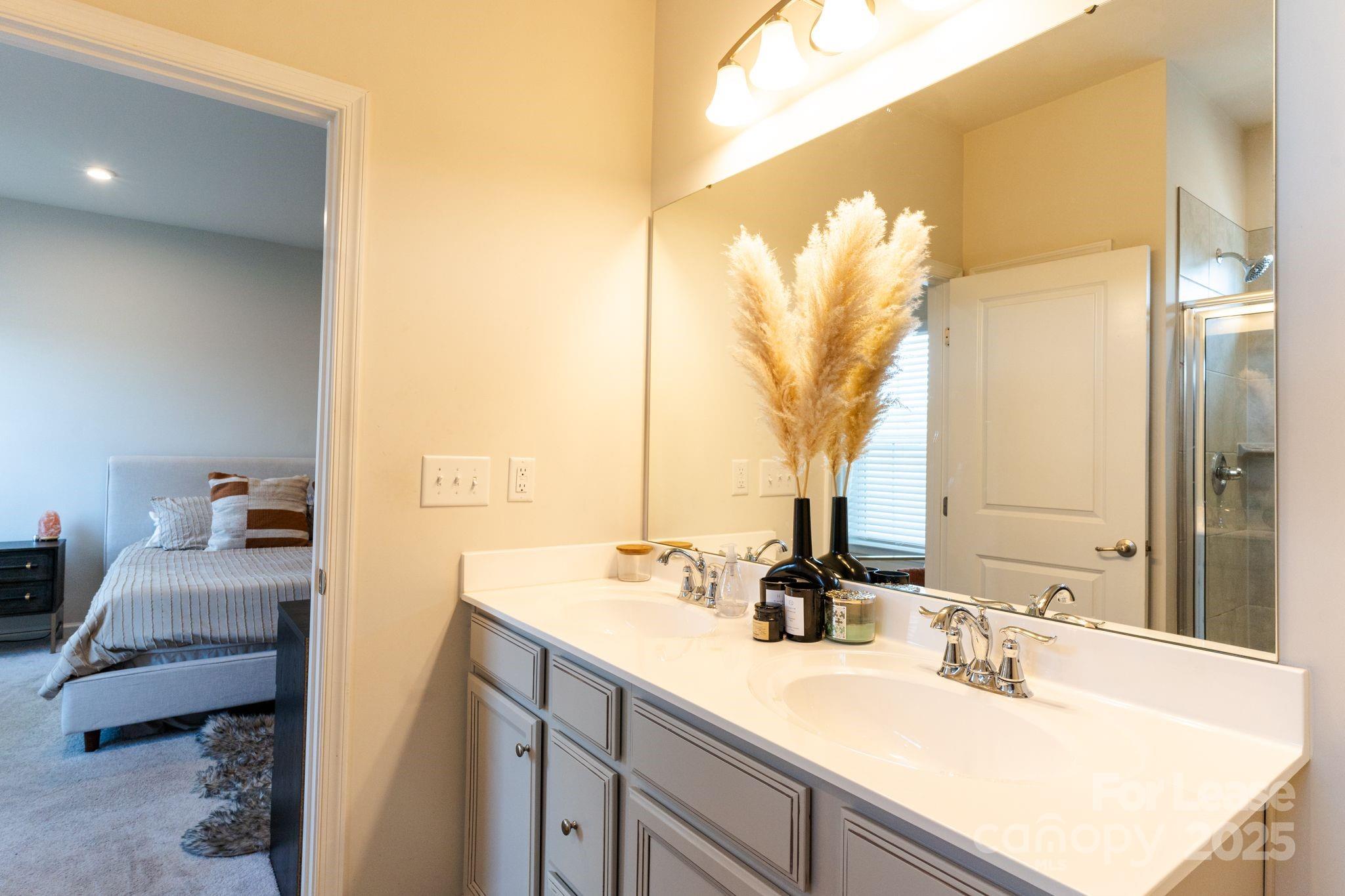 5048 Patton Dr. Gastonia, NC 28056 - Photo 22 of 37 a en suite bathroom with a sink and mirror