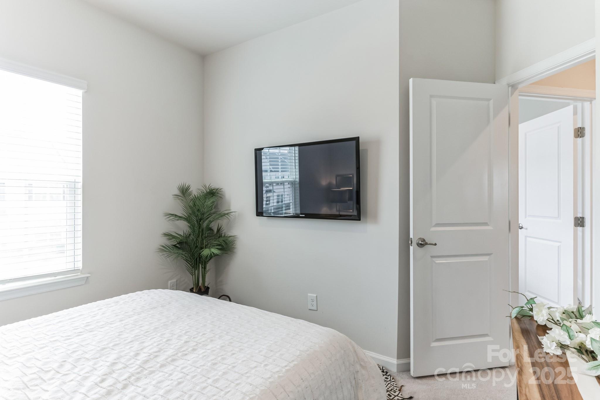 5048 Patton Dr. Gastonia, NC 28056 - Photo 27 of 37 a bedroom with a bed and a potted plant