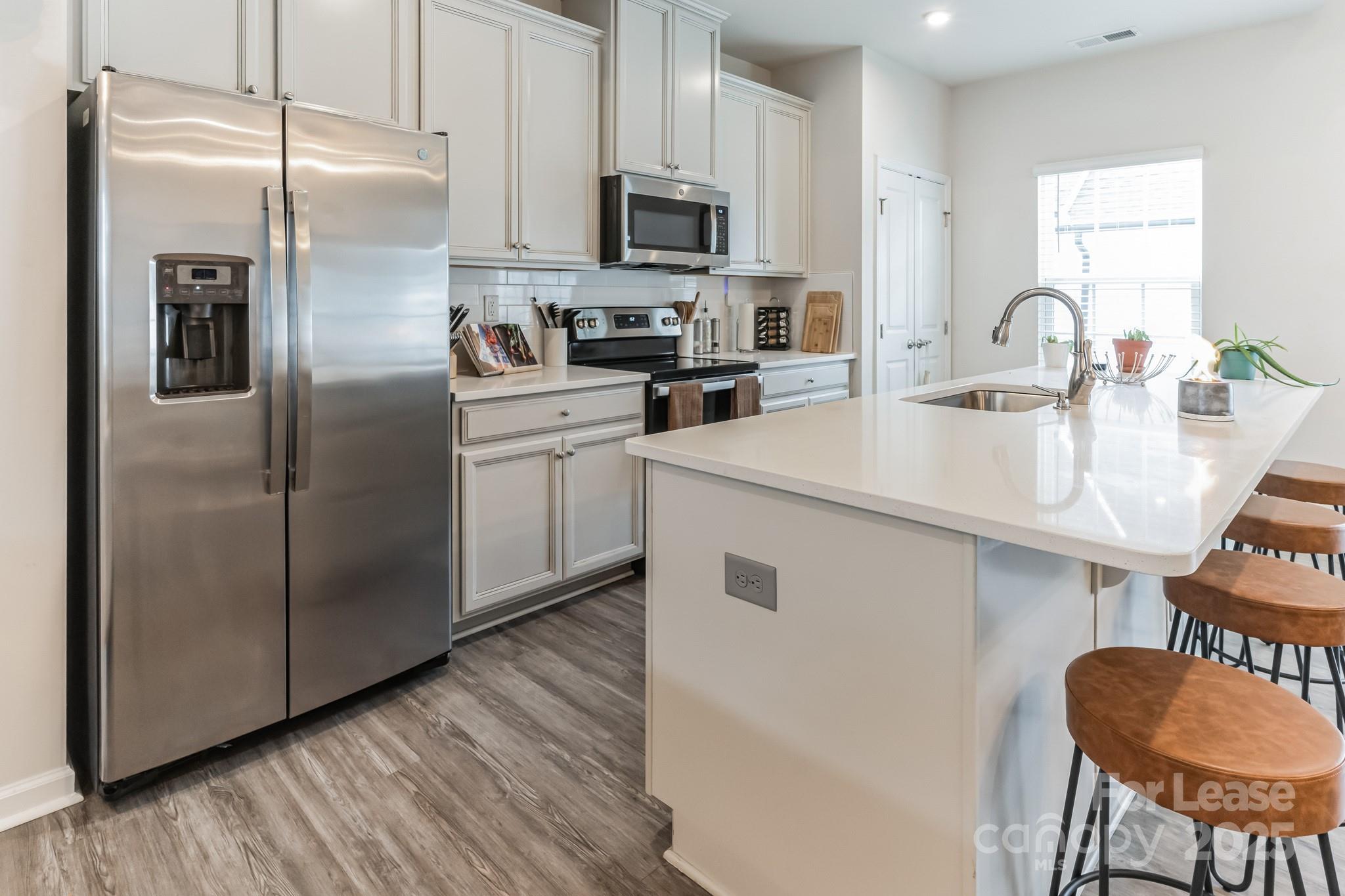 5048 Patton Dr. Gastonia, NC 28056 - Photo 9 of 37 a kitchen with stainless steel appliances granite countertop a refrigerator a stove a sink and a microwave