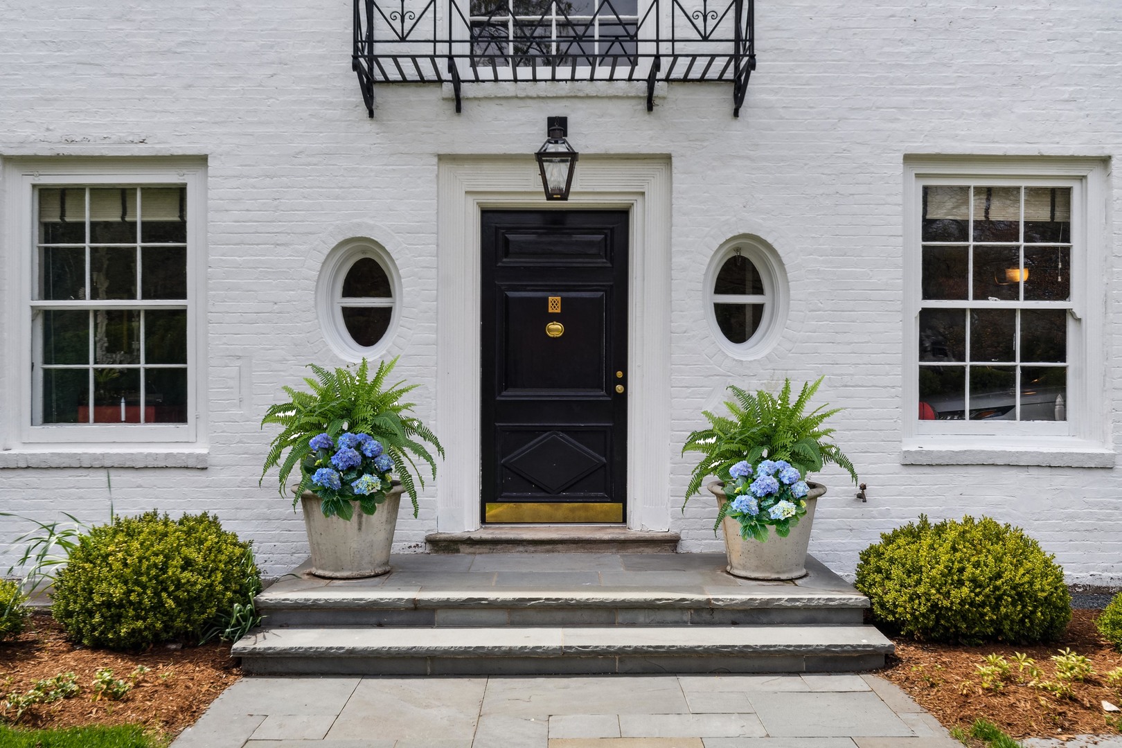 220 Dewindt Road Winnetka, IL 60093 - Photo 2 of 53 a potted plant sitting in front of a house