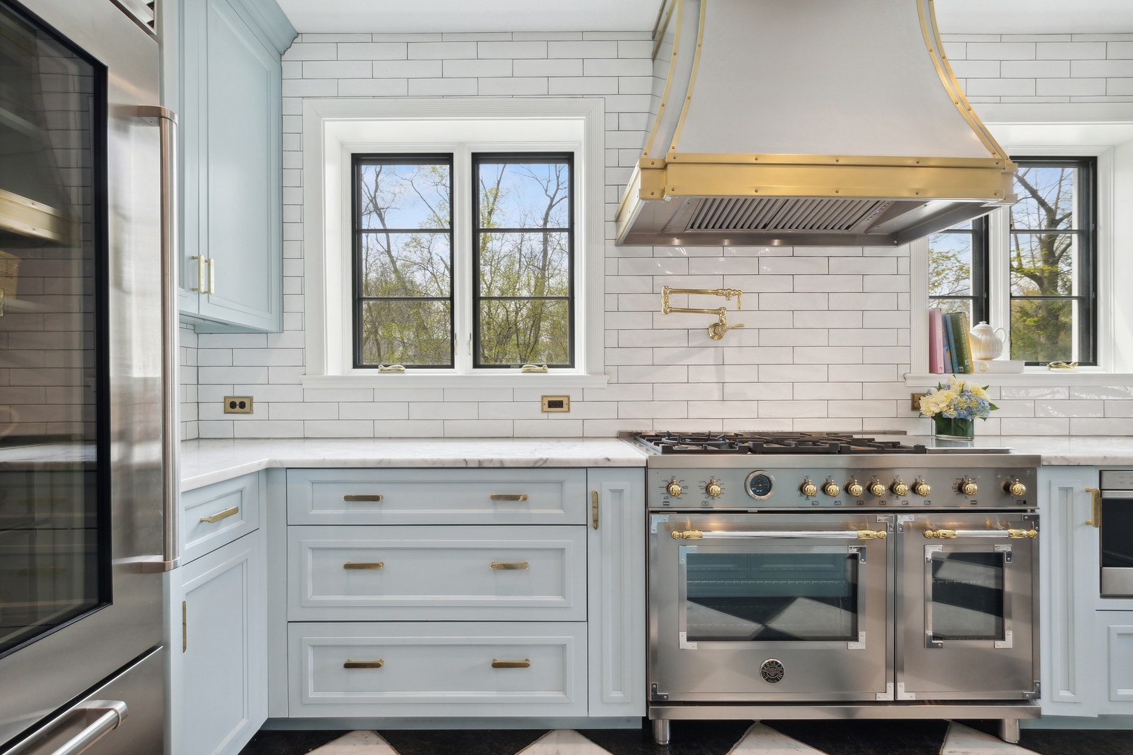 220 Dewindt Road Winnetka, IL 60093 - Photo 22 of 53 a kitchen with granite countertop white cabinets and a stove