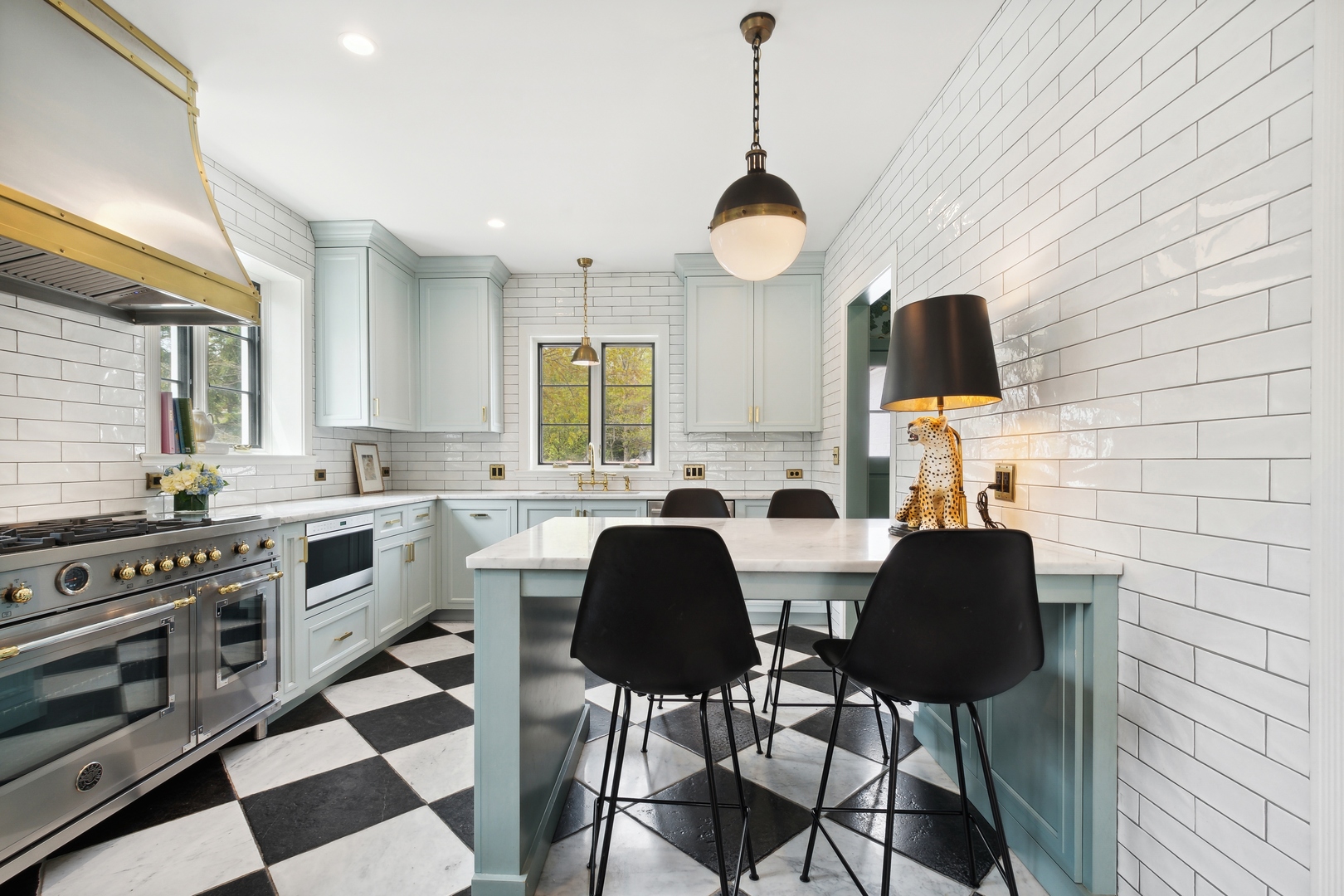 220 Dewindt Road Winnetka, IL 60093 - Photo 23 of 53 a kitchen with stainless steel appliances a stove a sink a dining table and chairs