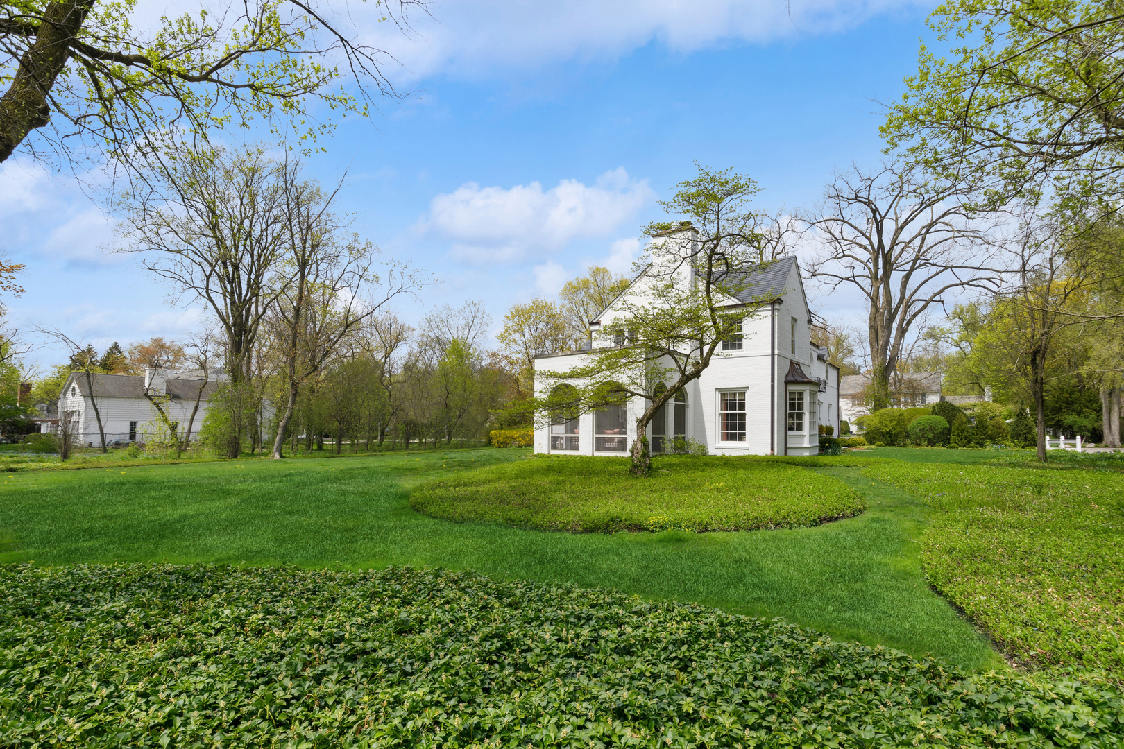 220 Dewindt Road Winnetka, IL 60093 - Photo 47 of 53 a front view of a house with a garden