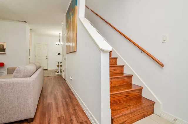a view of entryway and hall with wooden floor