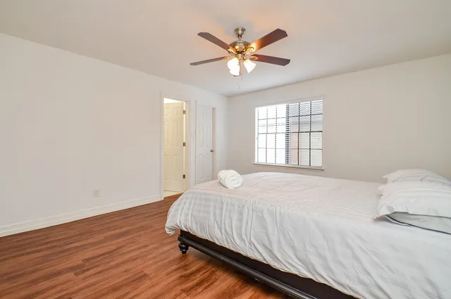 a bedroom with a large bed and a chandelier